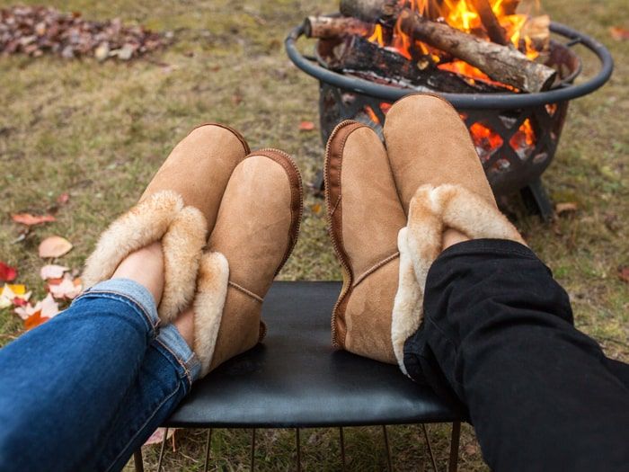 Sheepskin slippers by an outdoor fire