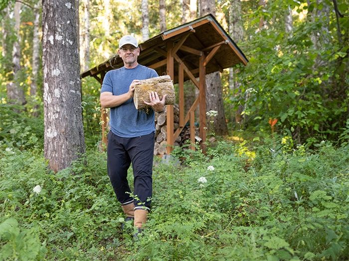 Man in phoenix boots carrying firewood