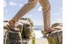 man crossing beach boulders in camino sandals