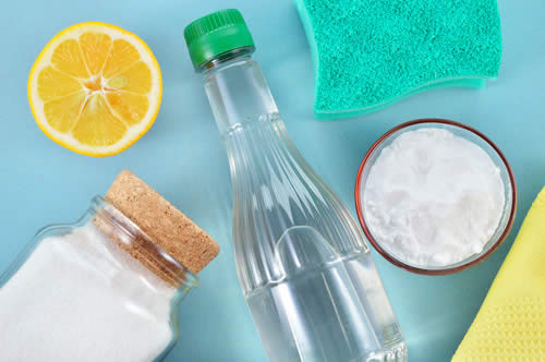 Why Do Shoes Smell, and What Can You Do About It? table with cleaning supplies: baking soda, salt, vinegar, lemon, sponge