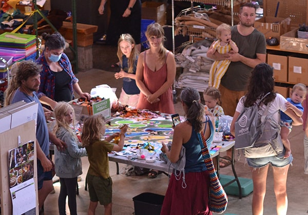People gathering around the leather mosaic