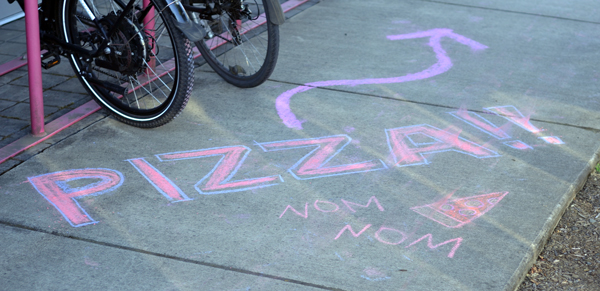 Pizza written in sidewalk chalk