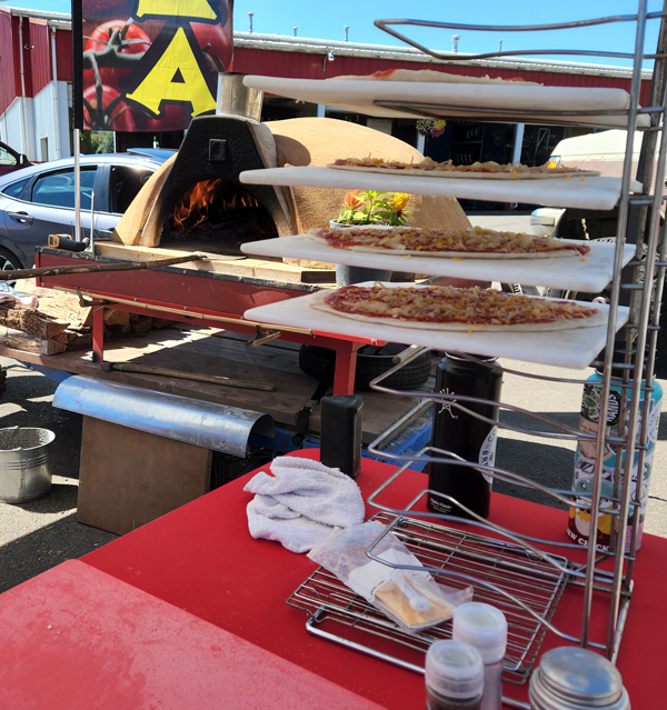 Pizza being prepared for the oven