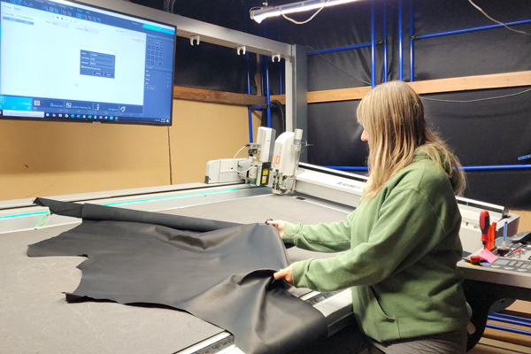 Nicole prepping the Chelsea leather to be cut